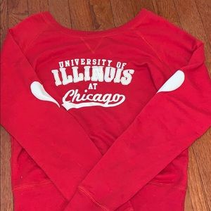 Red UIC sweater with white hearts on the elbows.